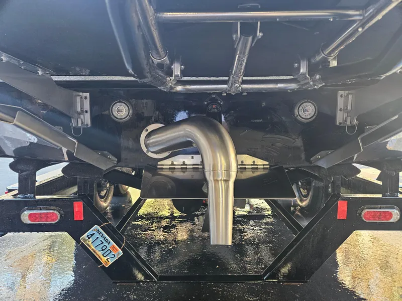 Slide: The Image of 2020 Tigé 25ZX boat on trailer, rear view showing exhaust and license plate. - 26