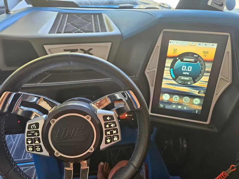 Slide: The Image of 2020 Tigé 25ZX boat dashboard with touchscreen display and multifunction steering wheel. - 48