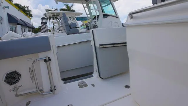 Slide: The Image of 2025 Boston Whaler 280 Outrage boat interior with seating and helm station. - 11