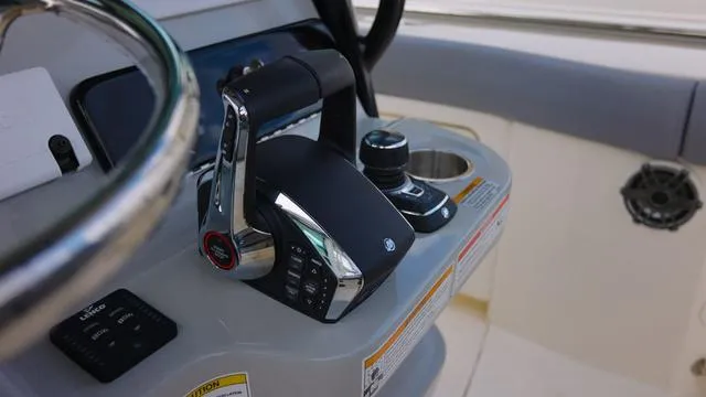 Slide: The Image of Close-up of 2025 Boston Whaler 280 Outrage boat controls and steering wheel. - 13