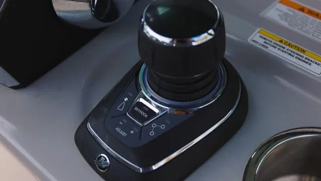 Slide: The Image of Boston Whaler 280 Outrage 2025 joystick control system on dashboard. - 14