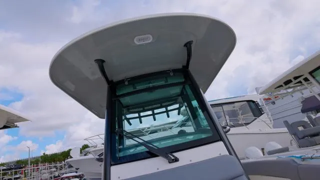 Slide: The Image of 2025 Boston Whaler 280 Outrage boat, featuring a sleek design and modern canopy. - 16