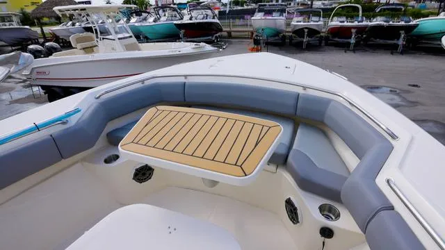 Slide: The Image of 2025 Boston Whaler 280 Outrage boat interior with seating and table. - 19