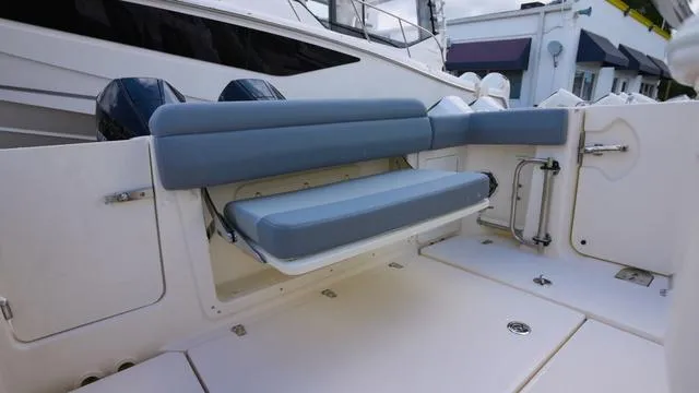 Slide: The Image of 2025 Boston Whaler 280 Outrage boat interior with foldable seating and sleek design. - 5