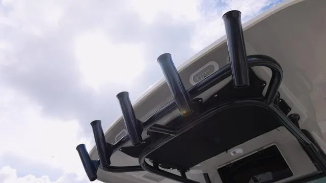 Slide: The Image of Boston Whaler 280 Outrage 2025 boat with rod holders against a cloudy sky. - 6