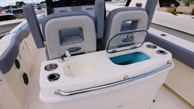 Slide: The Image of 2025 Boston Whaler 280 Outrage boat console with sink and storage. - 7