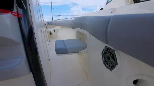 Slide: The Image of 2025 Boston Whaler 280 Outrage boat interior with cushioned seating and speaker. - 9