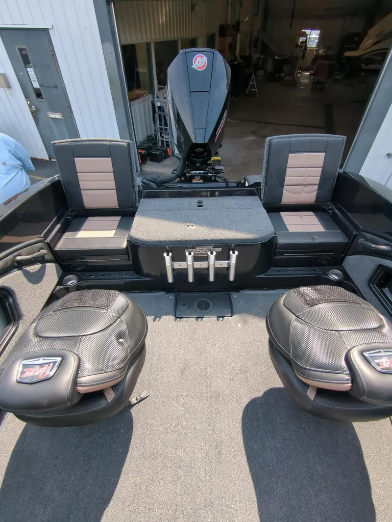 Slide: The Image of 2023 Ranger 2080MS boat interior with seating and motor in a garage setting. - 14