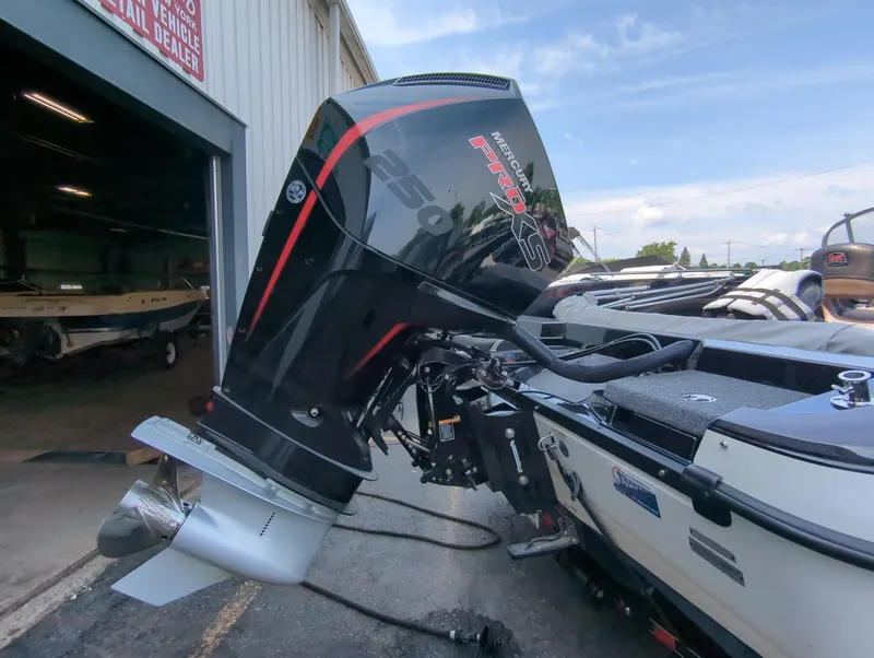 Slide: The Image of 2023 Ranger 2080MS boat with powerful outboard motor, parked outside a dealership. - 5