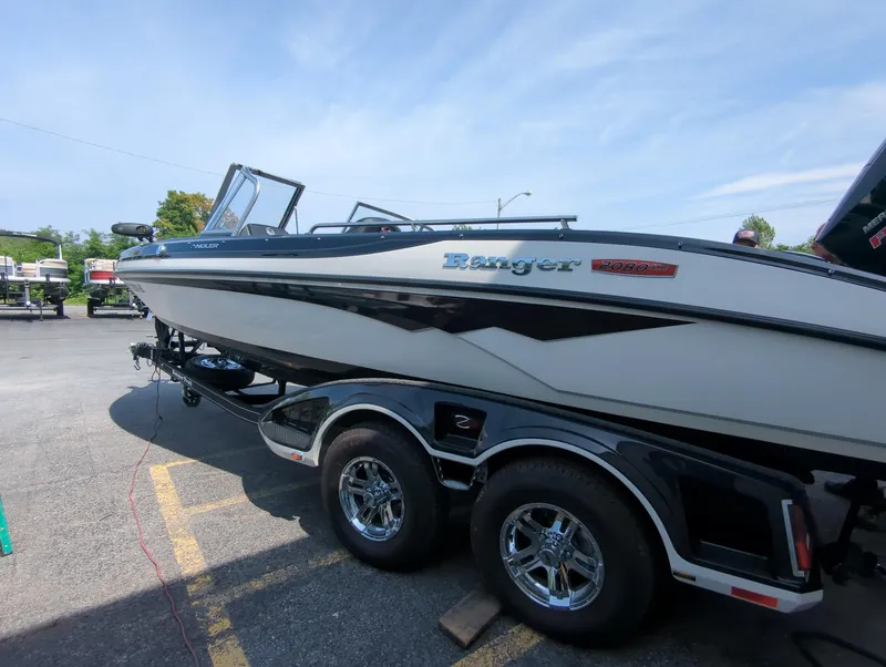 Slide: The Image of 2023 Ranger 2080MS boat on trailer, parked outdoors under clear sky. - 6