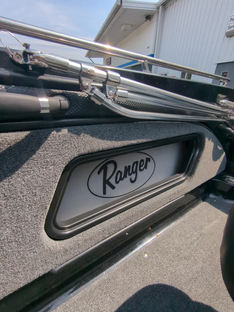 Slide: The Image of 2023 Ranger 2080MS boat interior with logo and fishing rod holders. - 9