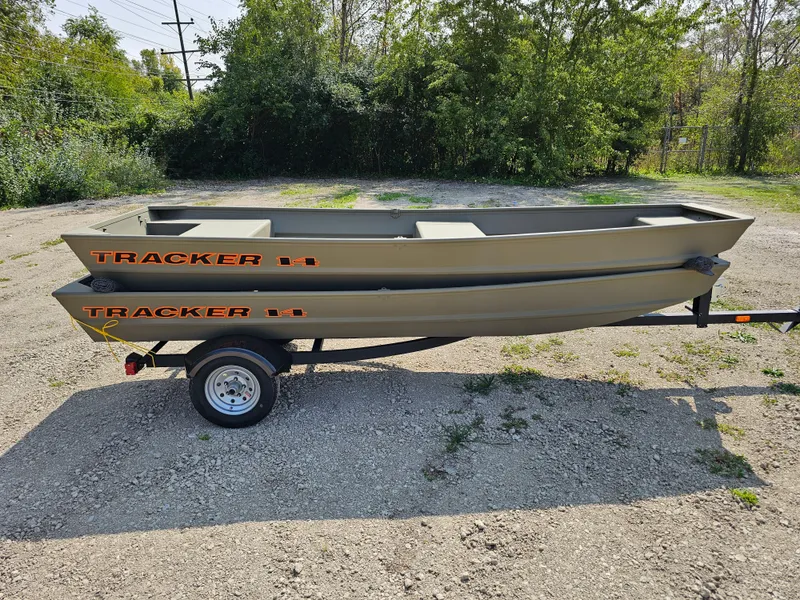Slide: The Image of 2025 Tracker Grizzly 1436 Utility boat on trailer in outdoor setting. - 2