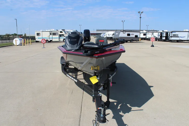 Slide: The Image of 2025 Tracker Pro Team 175 Crappie Edition boat on trailer in parking lot. - 2