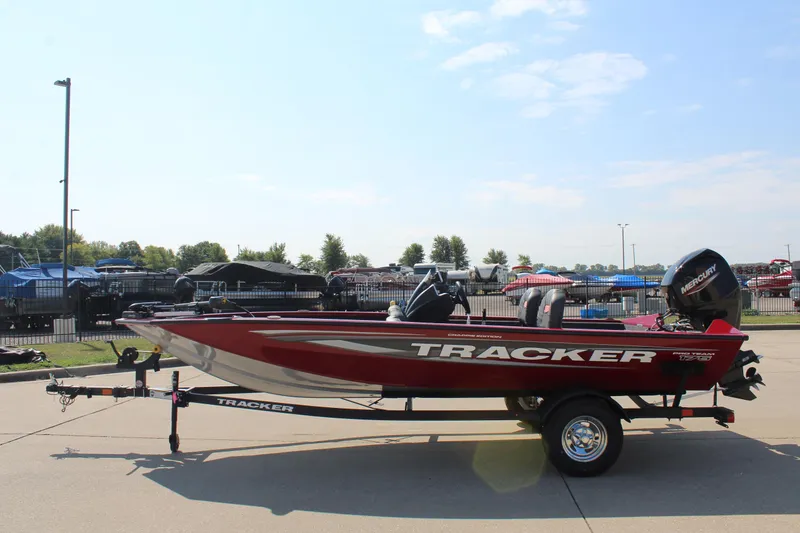 Slide: The Image of 2025 Tracker Pro Team 175 Crappie Edition boat on trailer, parked outdoors. - 4