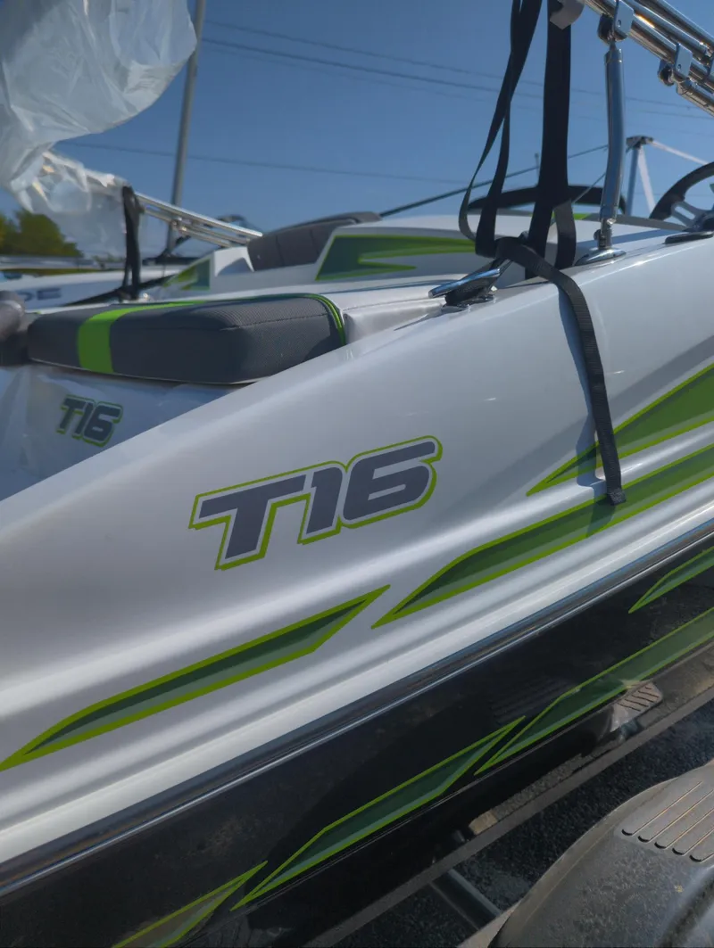 Slide: The Image of 2024 Tahoe T16 boat with green accents and sleek design. - 1