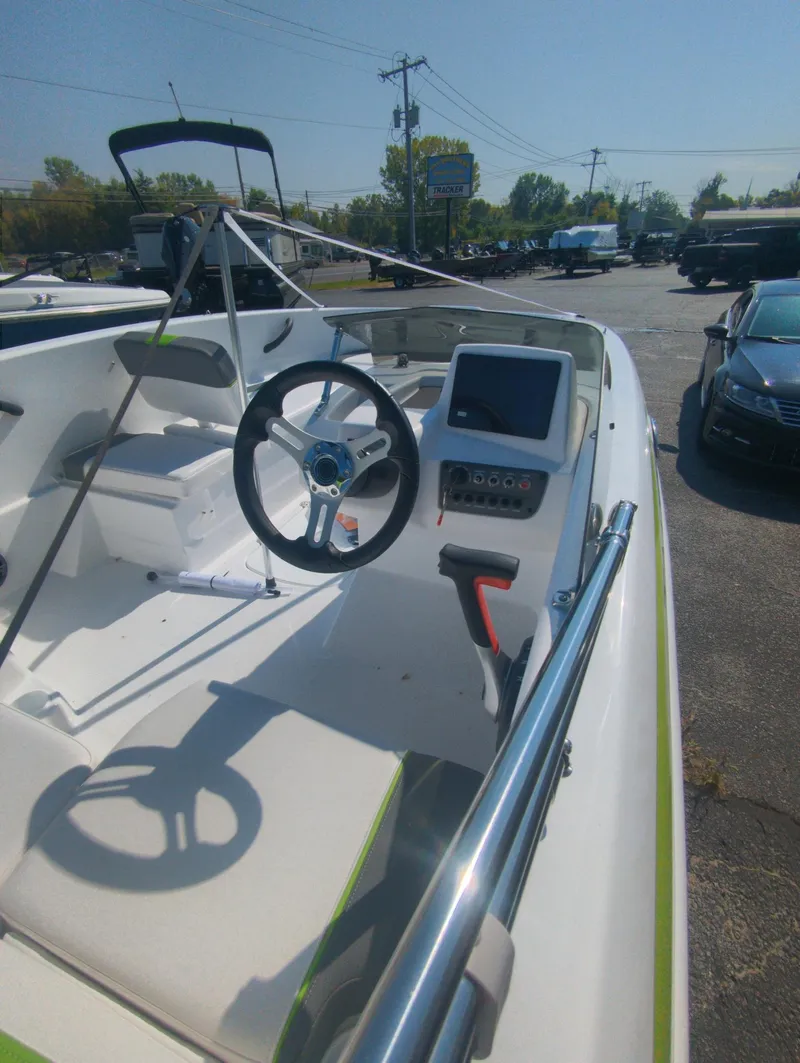 Slide: The Image of 2024 Tahoe T16 boat interior with steering wheel and control panel. - 9