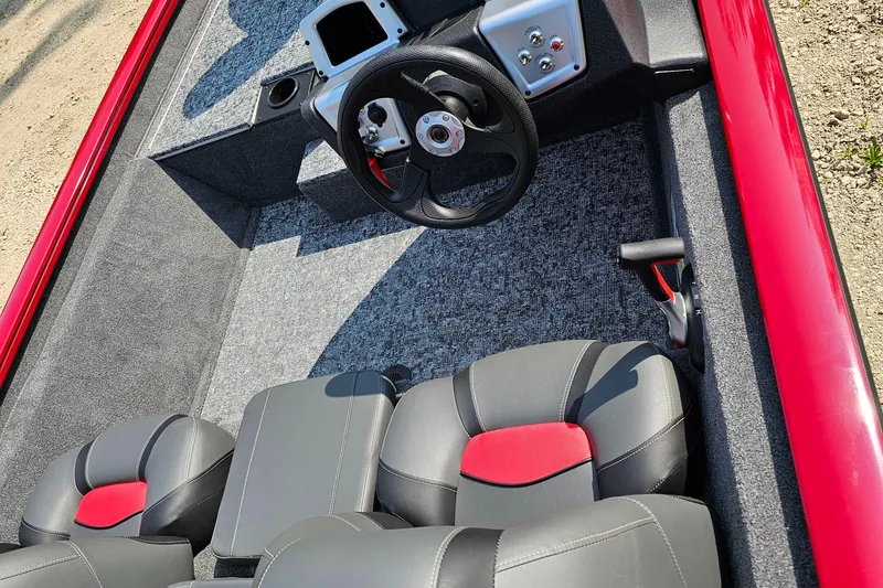 Slide: The Image of 2025 Tracker Pro Team 175 boat interior with steering wheel and seating. - 2