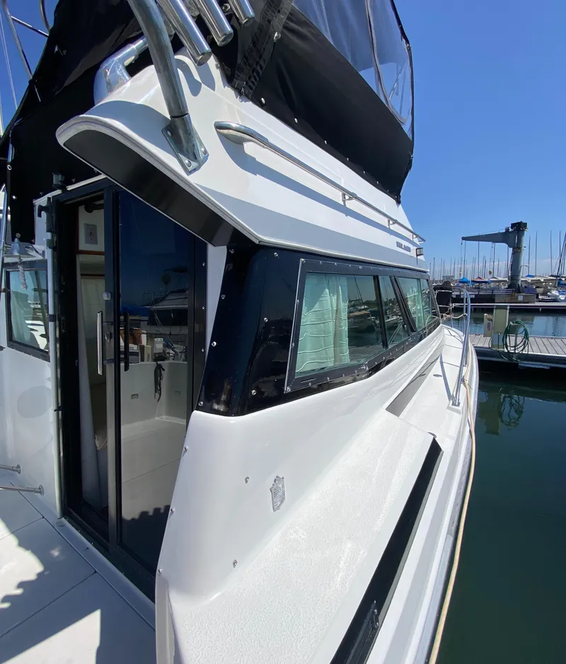 Slide: The Image of 1988 Chris-Craft 320 Amerosport Sedan docked at marina, side view. - 11
