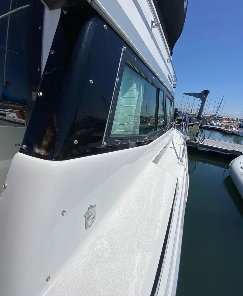 Slide: The Image of 1988 Chris-Craft 320 Amerosport Sedan docked at marina, side view. - 12