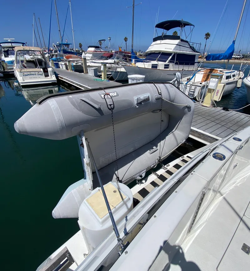 Slide: The Image of 1988 Chris-Craft 320 Amerosport Sedan docked with inflatable boat, marina background. - 14