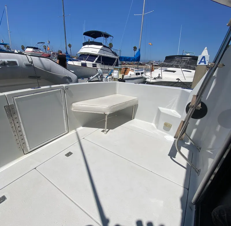 Slide: The Image of 1988 Chris-Craft 320 Amerosport Sedan boat deck in marina, clear sky background. - 15