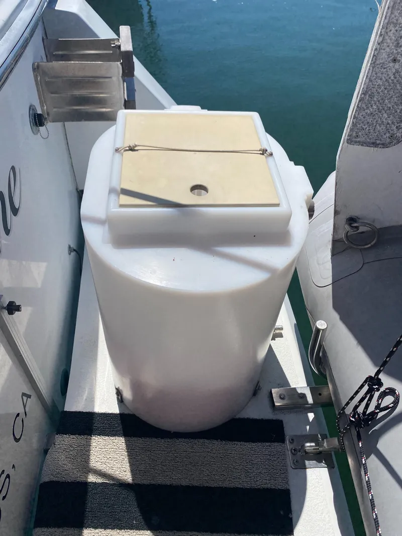 Slide: The Image of 1988 Chris-Craft 320 Amerosport Sedan with a white storage container on deck. - 17