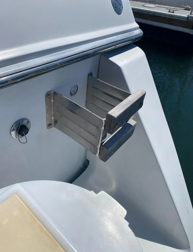Slide: The Image of 1988 Chris-Craft 320 Amerosport Sedan swim ladder detail by the water. - 18
