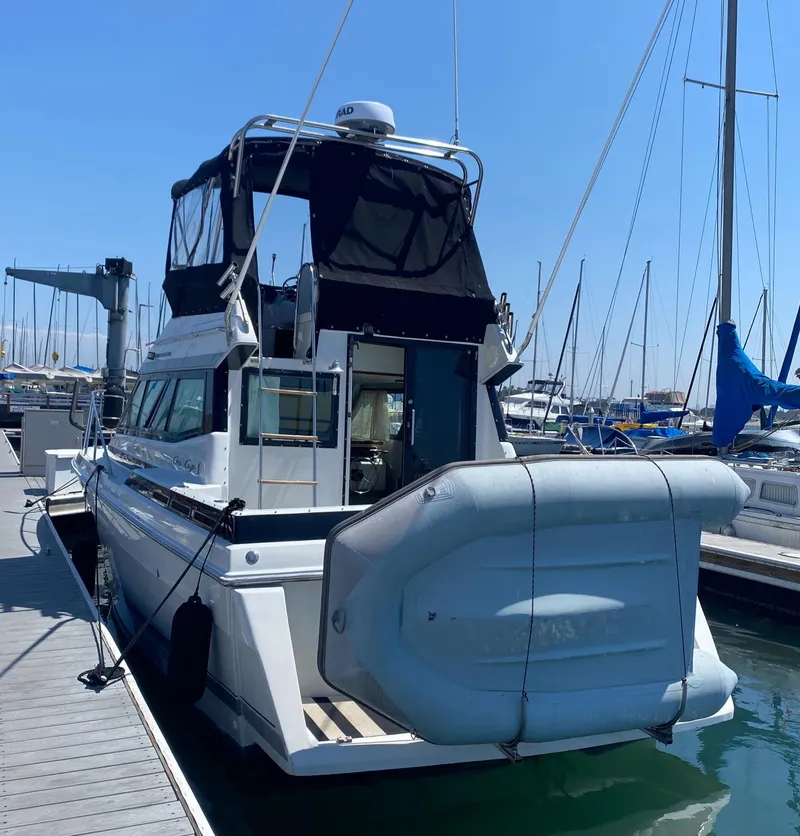 Slide: The Image of 1988 Chris-Craft 320 Amerosport Sedan docked at marina, rear view. - 20