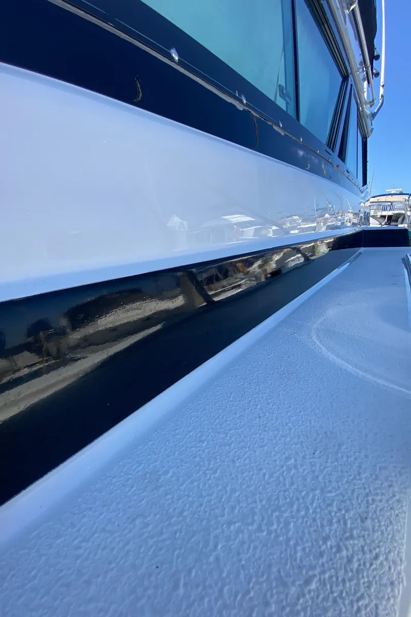 Slide: The Image of 1988 Chris-Craft 320 Amerosport Sedan boat exterior, sleek design with blue and white detailing. - 22