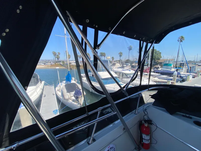 Slide: The Image of 1988 Chris-Craft 320 Amerosport Sedan at marina, view from cockpit with clear skies. - 23