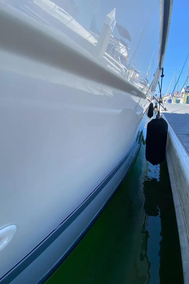 Slide: The Image of 1988 Chris-Craft 320 Amerosport Sedan docked, side view with water reflection. - 27