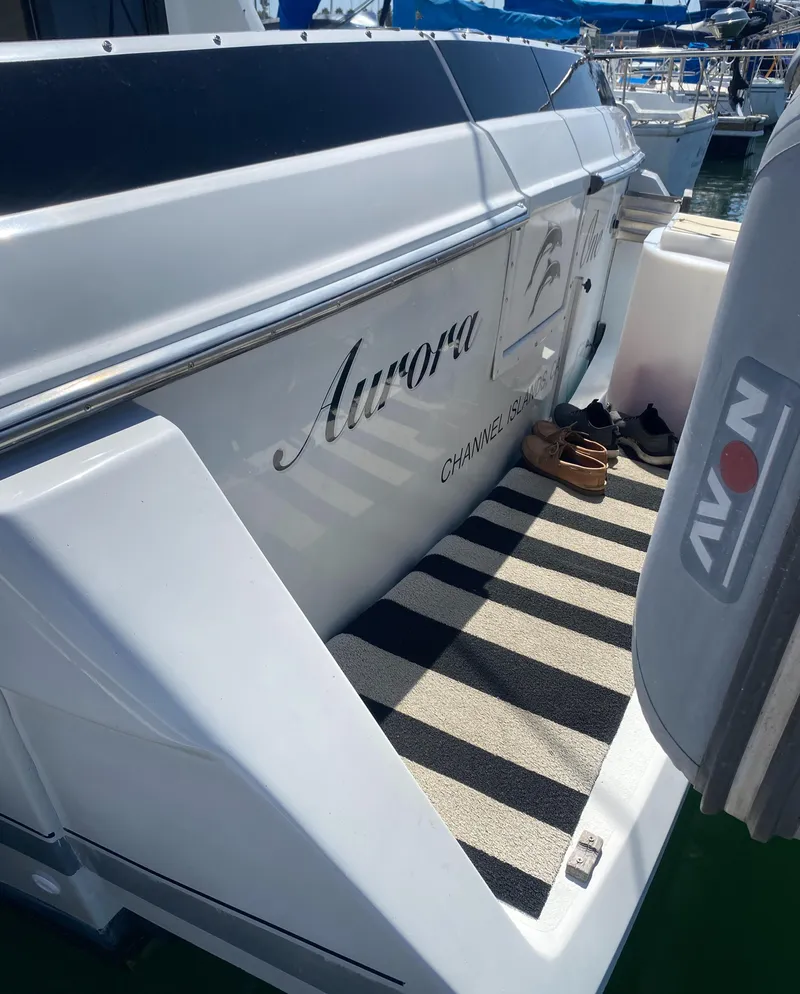 Slide: The Image of 1988 Chris-Craft 320 Amerosport Sedan boat docked, featuring "Aurora" name on the side. - 29