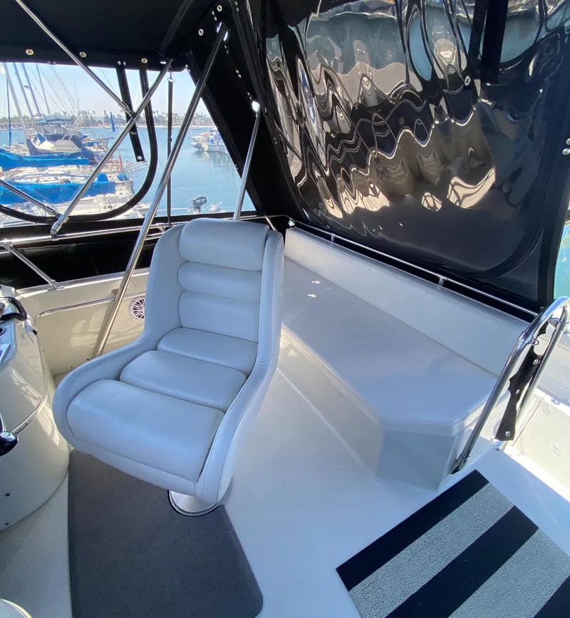 Slide: The Image of Interior of 1988 Chris-Craft 320 Amerosport Sedan with white seating and marina view. - 35