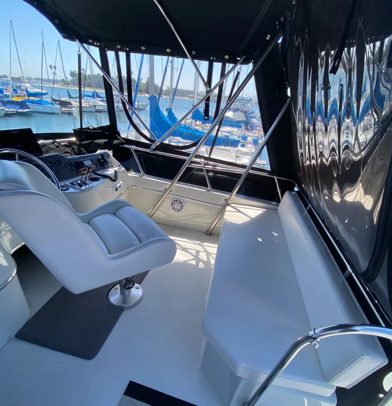 Slide: The Image of 1988 Chris-Craft 320 Amerosport Sedan interior with helm and seating, docked at marina. - 37