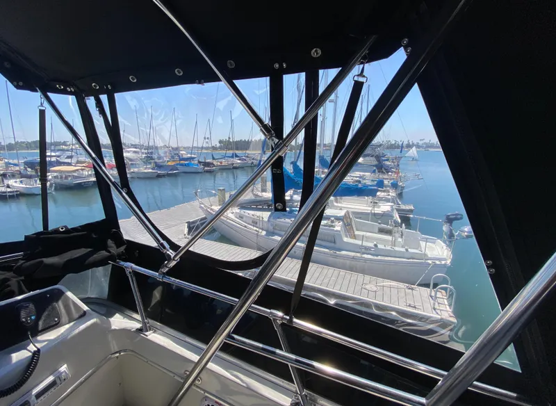 Slide: The Image of 1988 Chris-Craft 320 Amerosport Sedan interior view, overlooking marina with docked boats. - 38