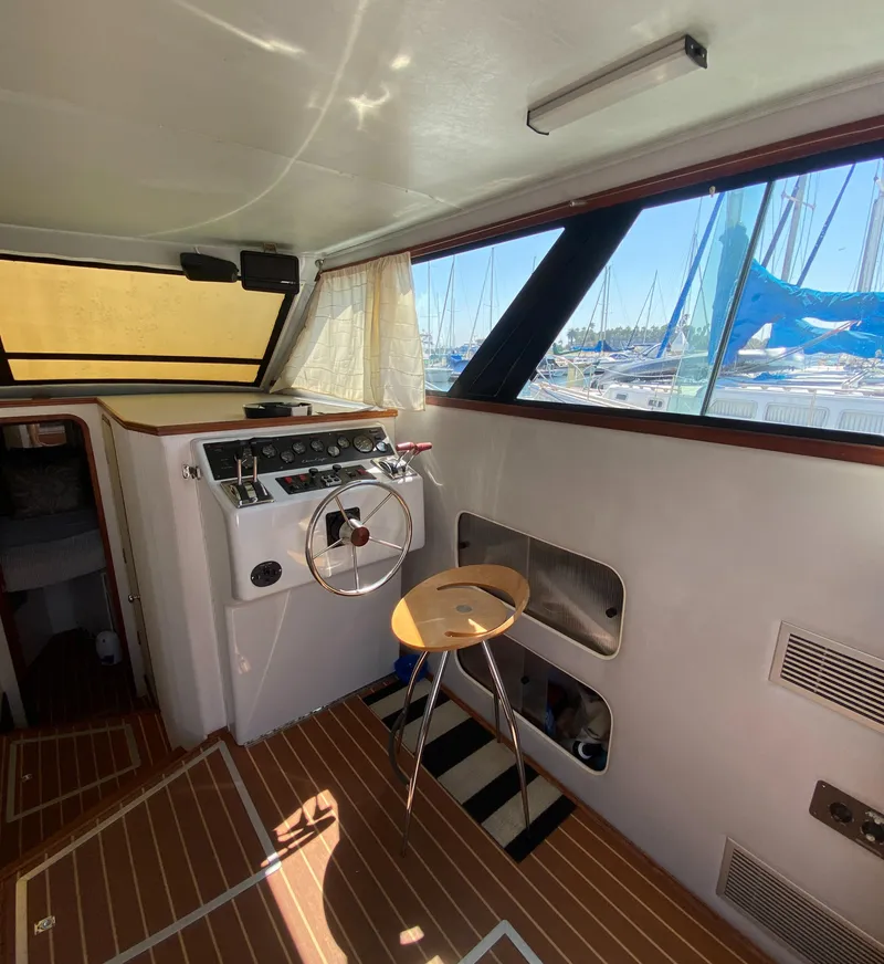 Slide: The Image of Interior of 1988 Chris-Craft 320 Amerosport Sedan with helm and marina view. - 39
