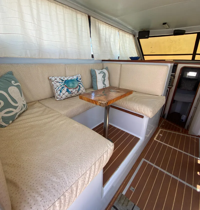Slide: The Image of Interior of 1988 Chris-Craft 320 Amerosport Sedan with cozy seating and nautical decor. - 40