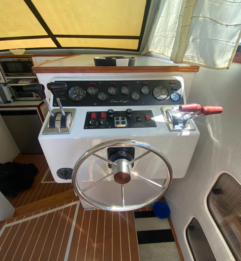 Slide: The Image of 1988 Chris-Craft 320 Amerosport Sedan helm with steering wheel and control panel. - 43