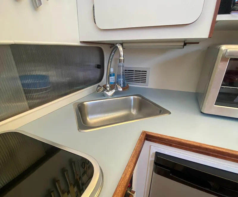 Slide: The Image of 1988 Chris-Craft 320 Amerosport Sedan kitchen with sink and appliances. - 48