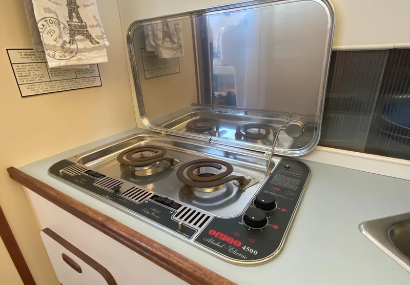Slide: The Image of 1988 Chris-Craft 320 Amerosport Sedan stove with two burners and protective cover. - 49