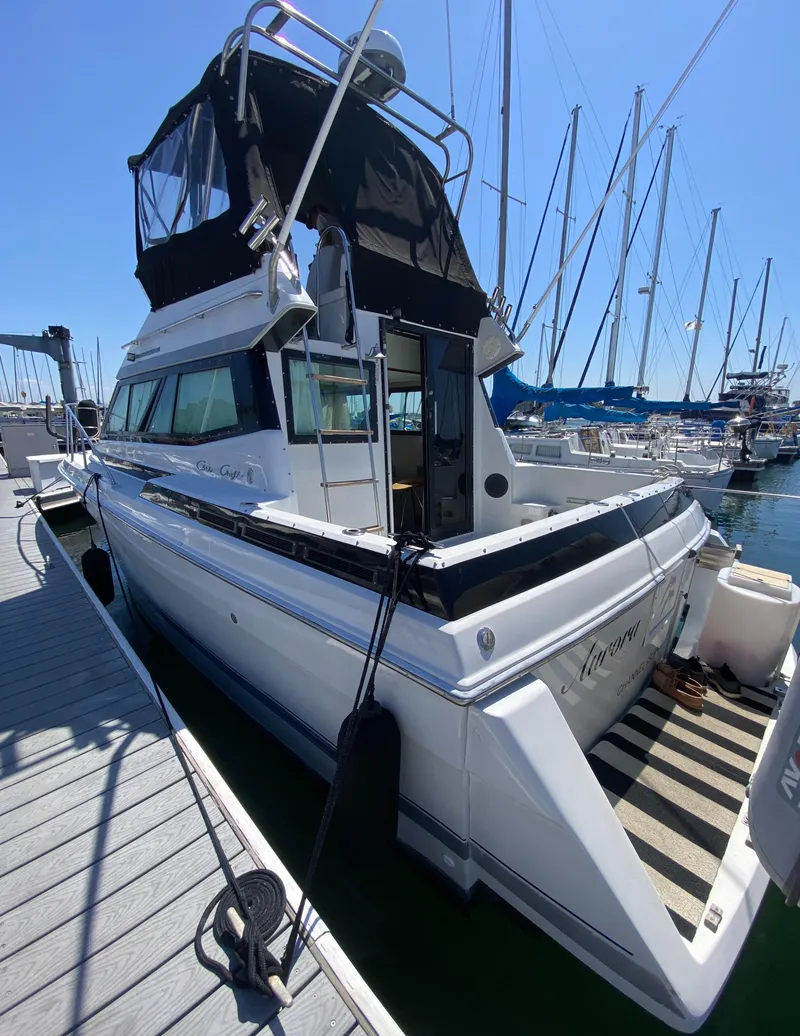 Slide: The Image of 1988 Chris-Craft 320 Amerosport Sedan docked at marina, side view. - 8