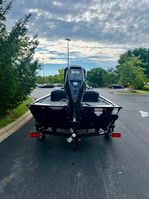 Slide: The Image of 2025 Tracker Pro 170 boat on trailer, parked outdoors under cloudy sky. - 5
