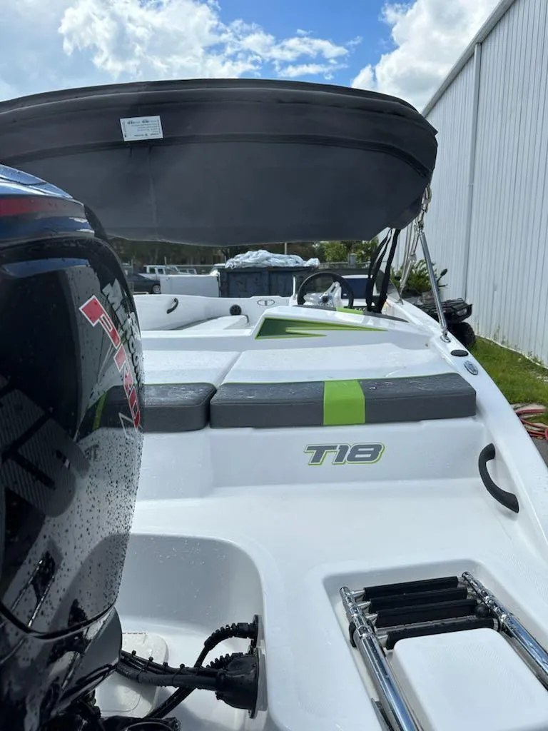 Slide: The Image of 2024 Tahoe T18 boat with outboard motor, sleek design, and modern seating. - 3