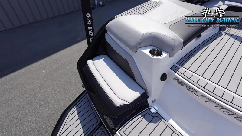 Slide: The Image of 2020 Nautique Super Air Nautique G23 boat seating area with Race City Marine branding. - 12