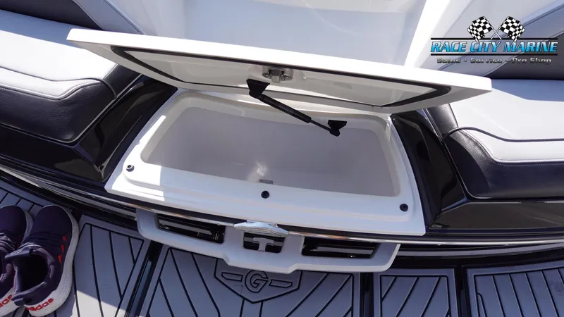 Slide: The Image of 2020 Nautique Super Air Nautique G23 open storage compartment on boat deck. - 14