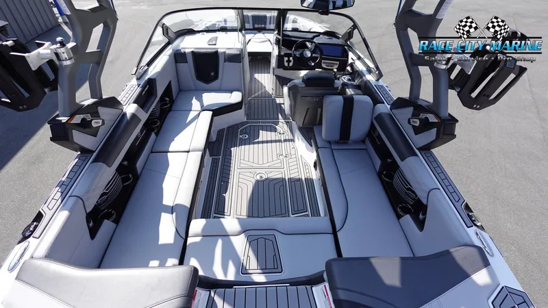 Slide: The Image of Interior of 2020 Nautique Super Air Nautique G23 boat with spacious seating and modern design. - 16