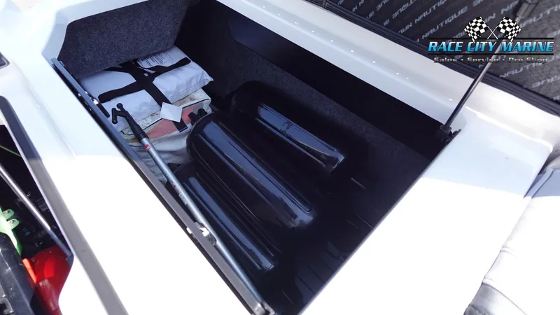 Slide: The Image of 2020 Nautique Super Air Nautique G23 storage compartment with equipment and accessories. - 21