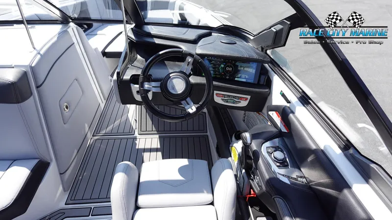 Slide: The Image of 2020 Nautique Super Air Nautique G23 boat interior with modern dashboard and steering wheel. - 41