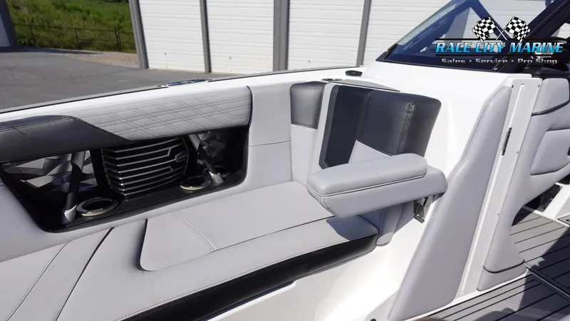 Slide: The Image of 2020 Nautique Super Air Nautique G23 interior seating with cup holders and sleek design. - 45