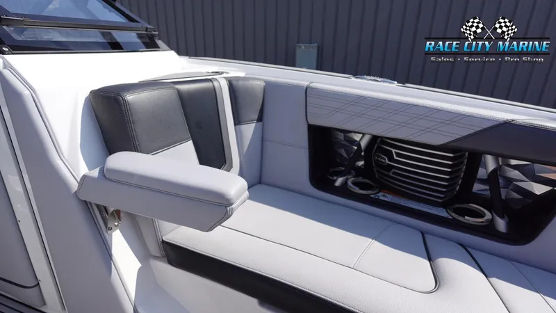Slide: The Image of 2020 Nautique Super Air Nautique G23 interior seating with armrest and cup holders. - 46